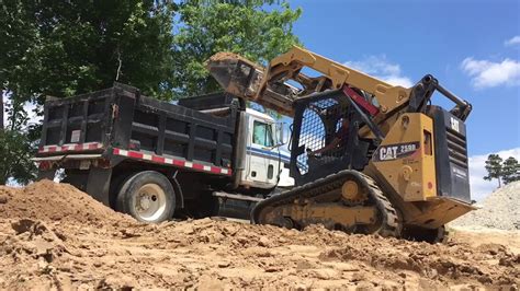 load a dump truck with a mini skid steer|mini flatbed truck haul.